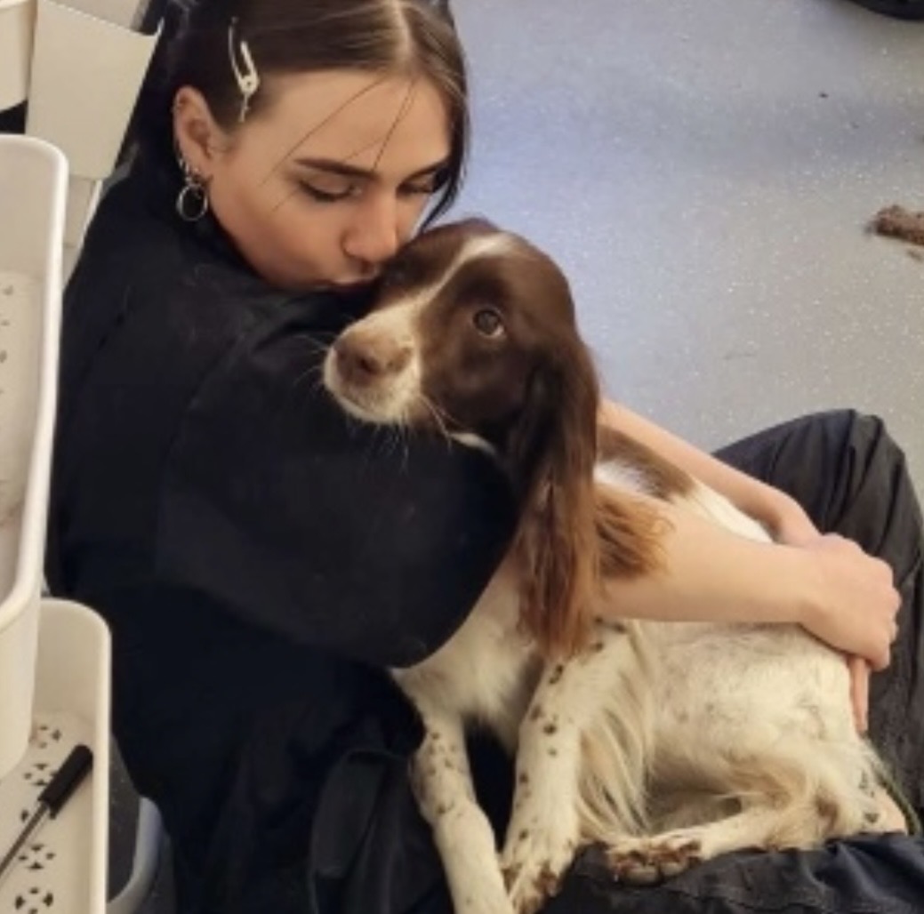Skye cuddling and kissing a spaniel